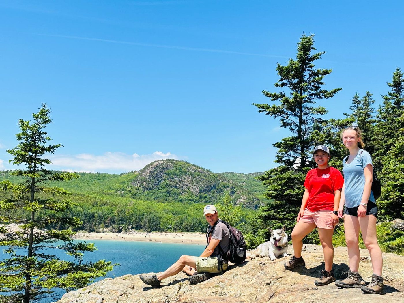 Sofia hiking with family and a dog overlooking a coastline